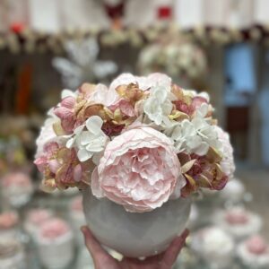Centrotavola con fiori artificiali composto da peonie rosa e ortensie bianche e rosa